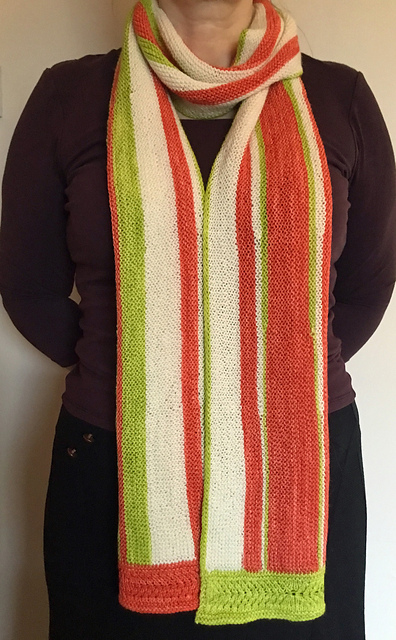 A lime green, white, and orange scarf with vertical stripes