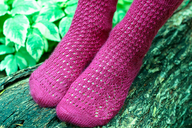 Red, purple, and cream striped socks with eyelet lace instep.