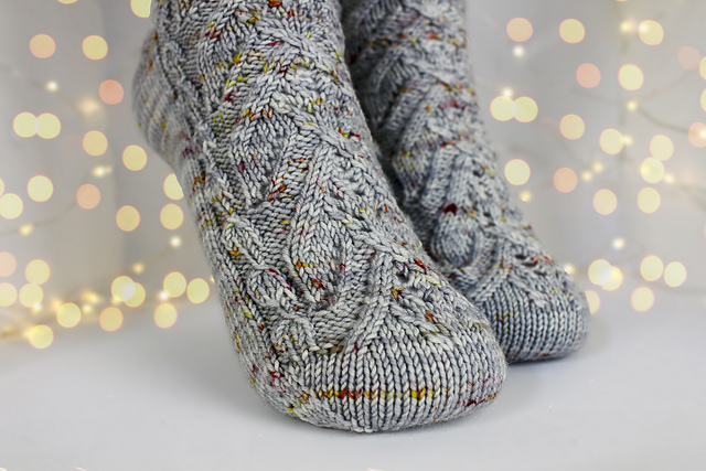 Grey cabled socks with red and yellow speckles