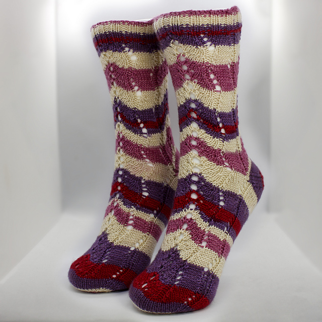Red, purple, and cream striped socks with eyelet lace instep.
