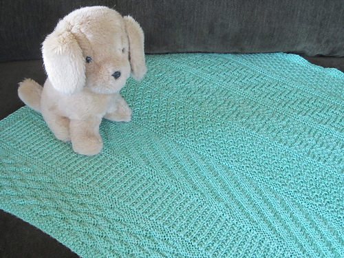 blanket with vertical bands of different stitch patterns.