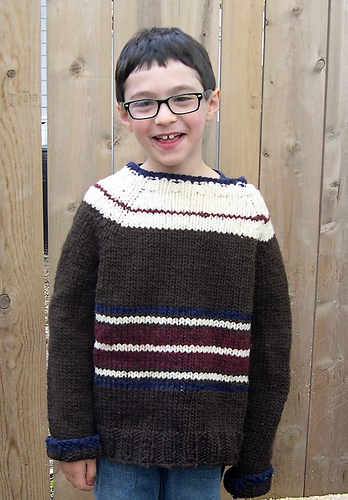 Child's long sleeve pullover sweater with stripes across the tummy and contrast color and pinstripe on the shoulders and upper part of the sweater