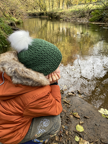 Circular knit hat with small ribbed brim and faux cables to the crown. Sized from baby to adult.