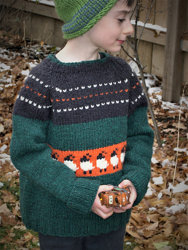 Relaxed fit long sleeved pullover child's sweater with sheep across the tummy, and decorative stripes across the shoulders and chest.