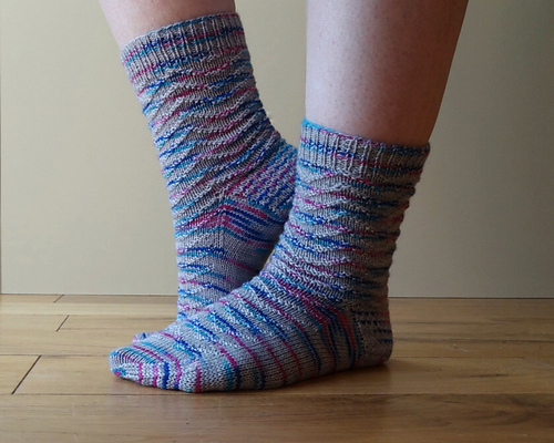 Top down sock with a stitch pattern that creates a wavy texture to the fabric