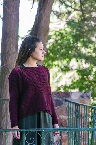 Pullover long sleeved sweater with square neckline, textured top and shoulders, stockinette bottom with small vents on the sides.