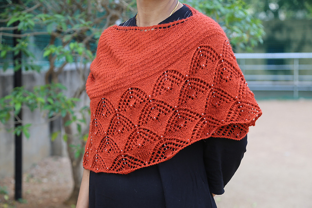 A red lace beaded crescent shawl