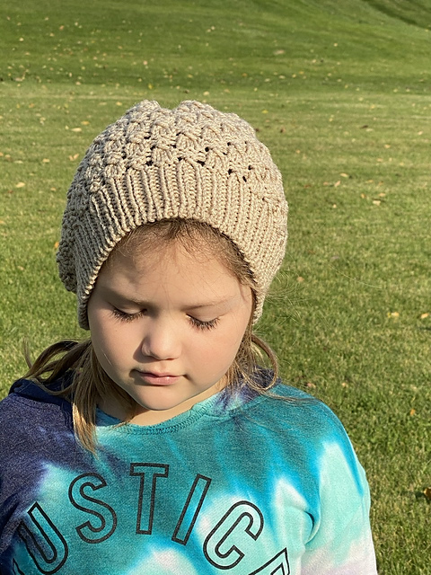 A child models a textured beige beanie